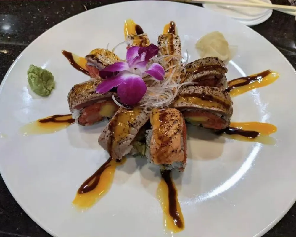 Seared tuna sushi roll with garnish and artistic sauce drizzles at Mici Asian Bistro，a Asian Fusion Restaurant in Trumbull