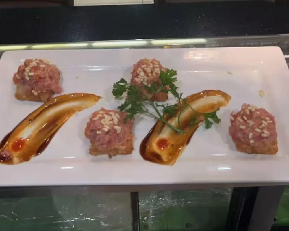 Tuna tartare appetizer bites topped with sesame seeds on crisp bases at Mici Asian Bistro，a Asian Fusion Restaurant in Trumbull