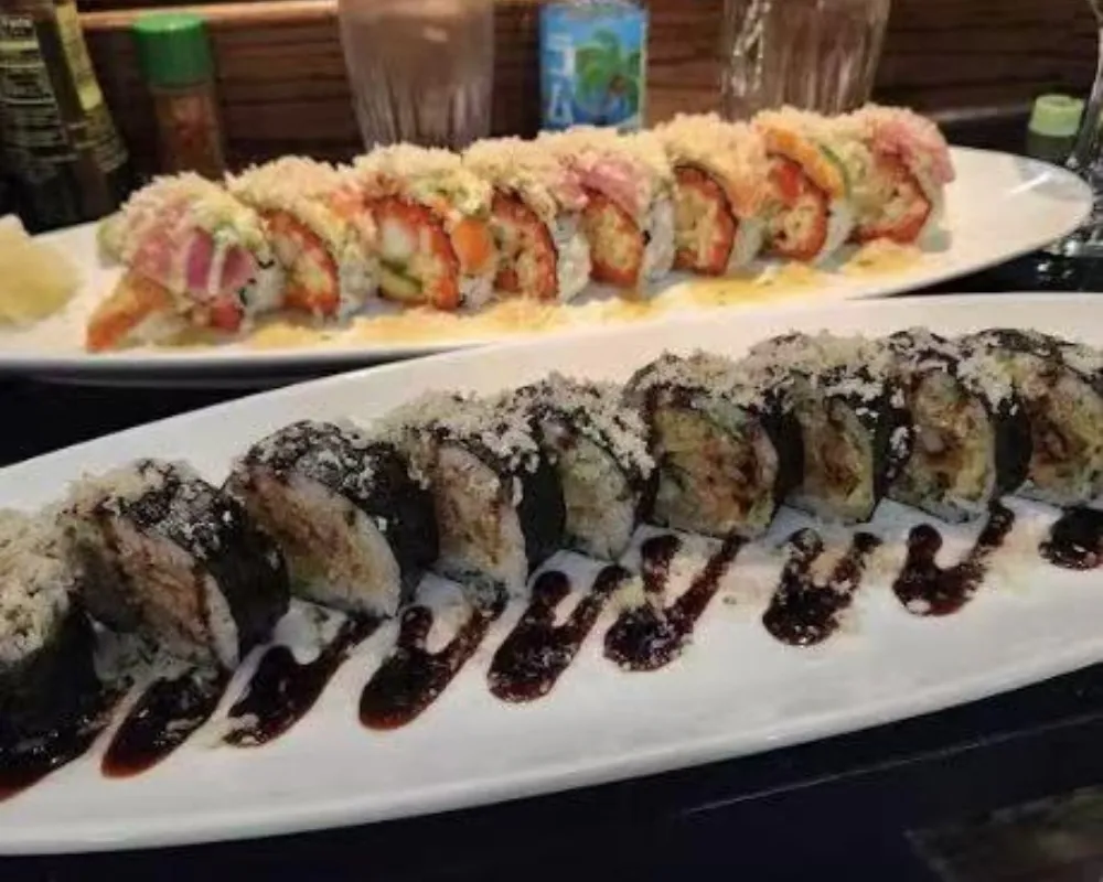 Two plates of crispy tempura sushi rolls with dark sauce drizzles at Mici Asian Bistro，a Asian Fusion Restaurant in Trumbull